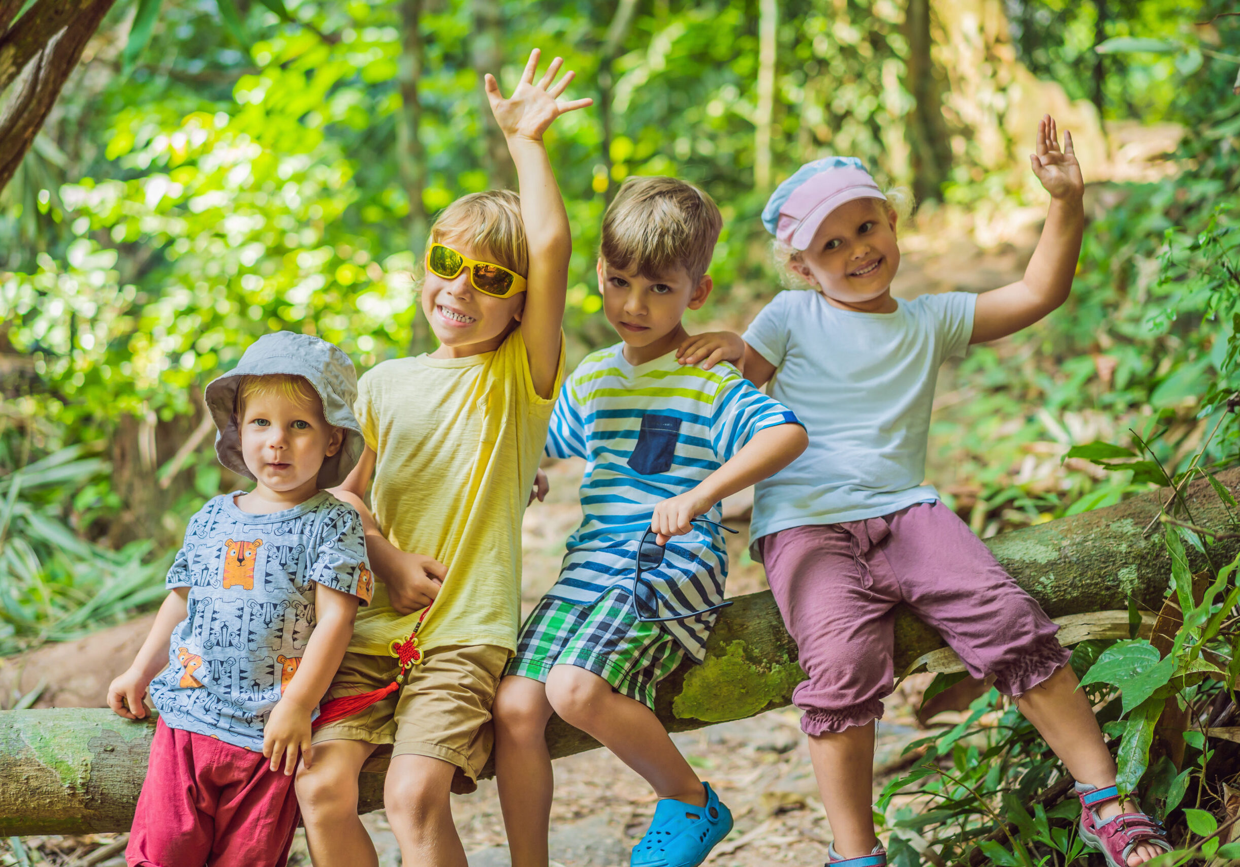 Children rest during a hike in the woods.